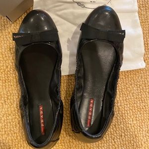Prada Milano black patent leather ballet flats.